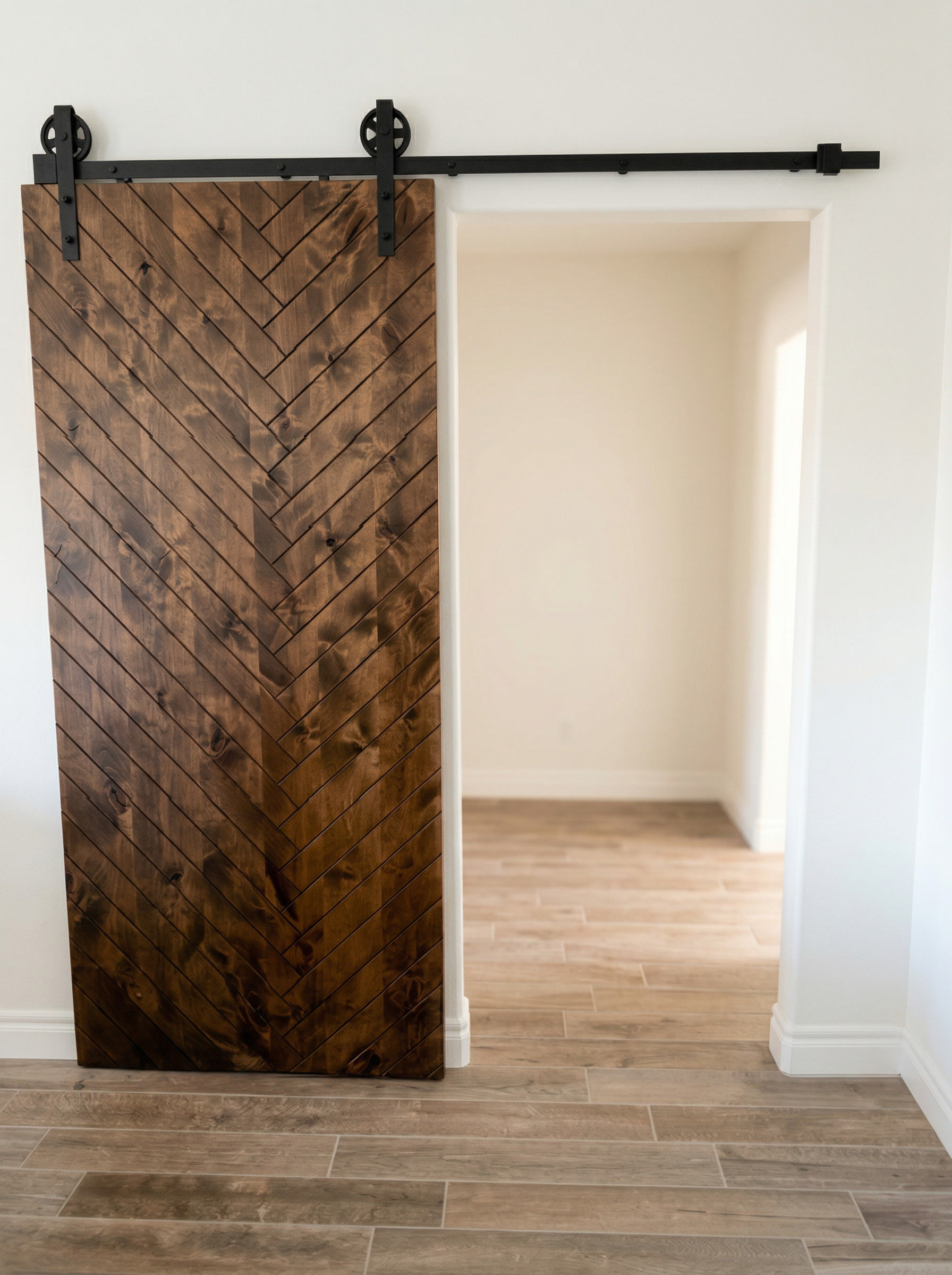 Herringbone pattern barn door with black sliding hardware