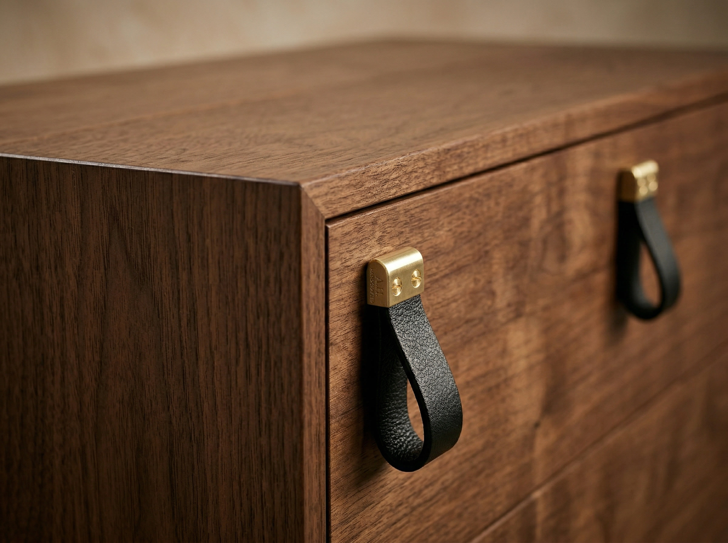 Close-up of leather and brass drawer pulls