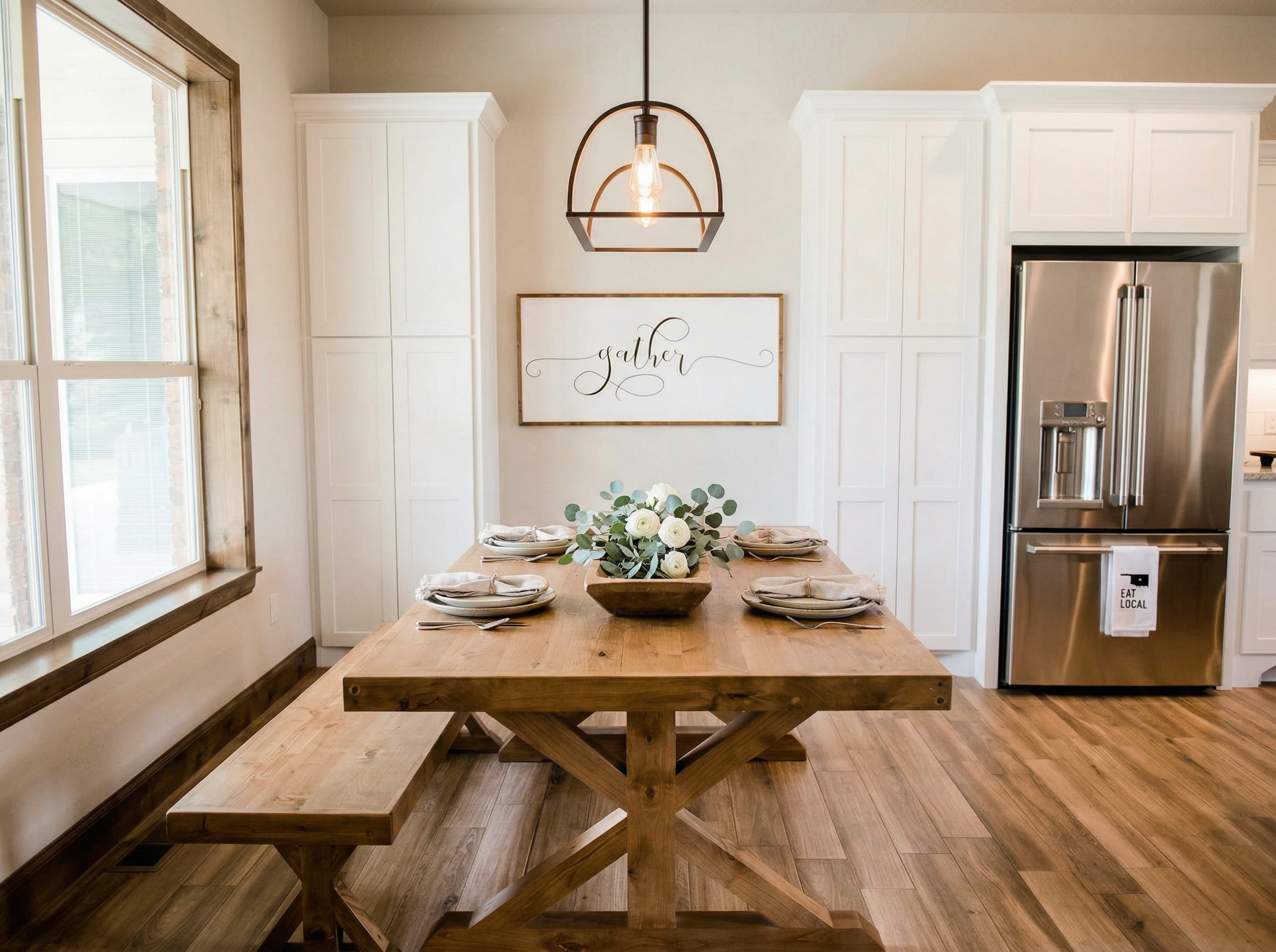 Farmhouse trestle table with bench and gather sign in kitchen